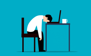 Man Falling Asleep on Desk